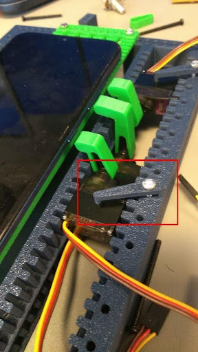 Servo hold down arm
